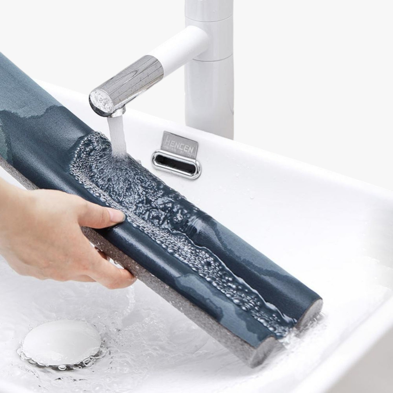 Roselva double-sided door weather stripping being washed under a faucet to demonstrate its durable, waterproof material.