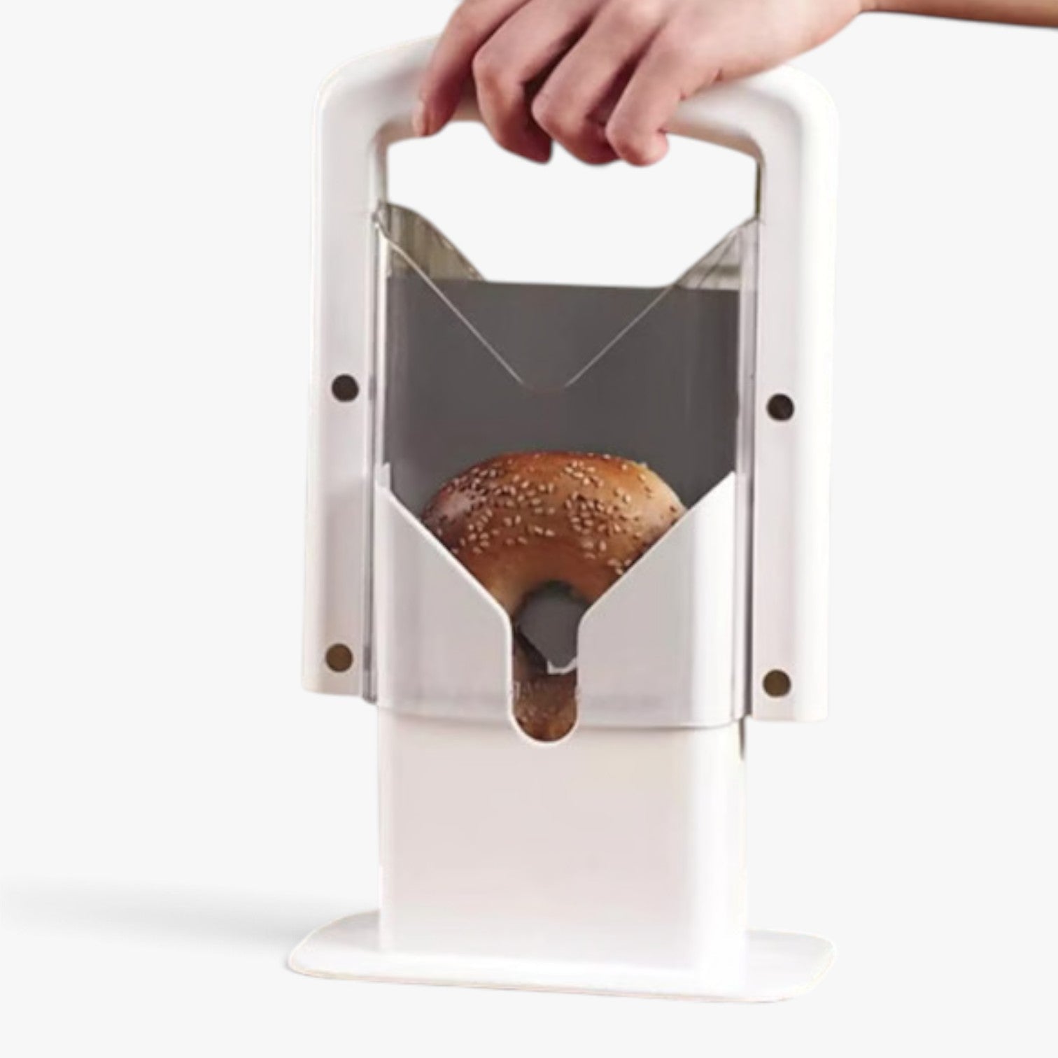 Roselva stainless steel guillotine bagel slicer with a white plastic frame slicing a sesame bagel safely