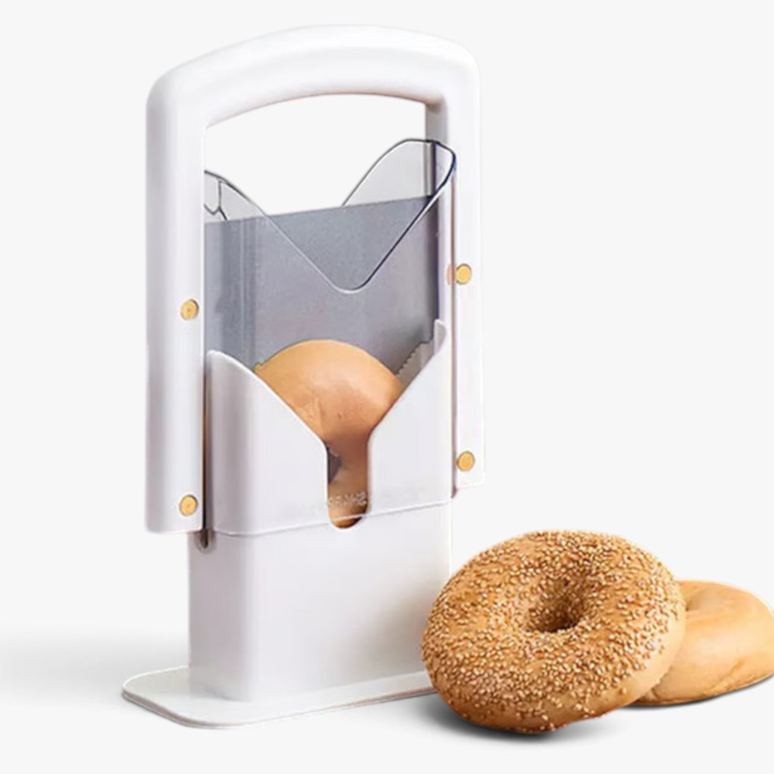 Roselva stainless steel guillotine bagel slicer with a white frame and serrated blade, next to two fresh bagels.