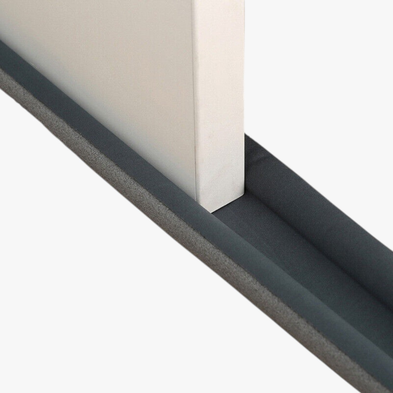 Roselva grey double-sided foam door bottom weather stripping seal installed on a white door for insulation