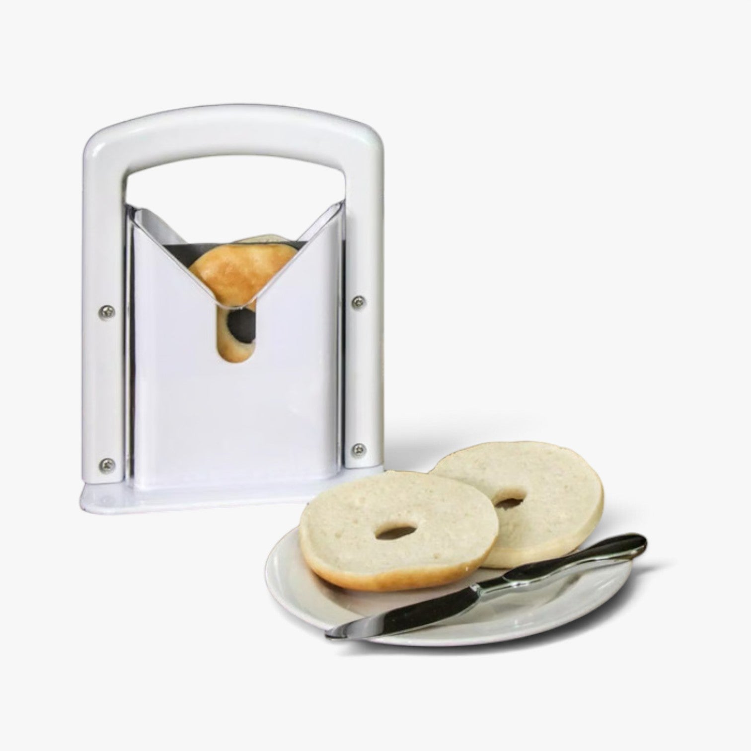 Roselva stainless steel guillotine bagel slicer with white frame and serrated blade, shown with sliced bagel on a plate